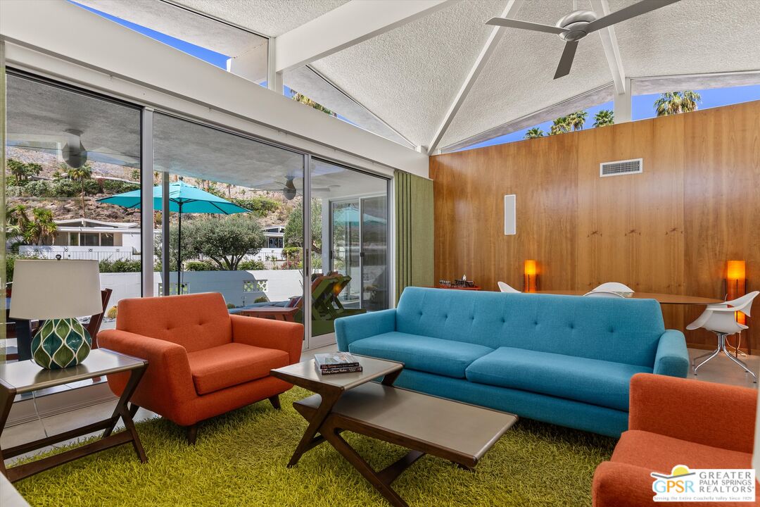 233 Toro Circle Palm Springs, CA 92264 - Photo 3 of 39 a living room with furniture a couch and a large window