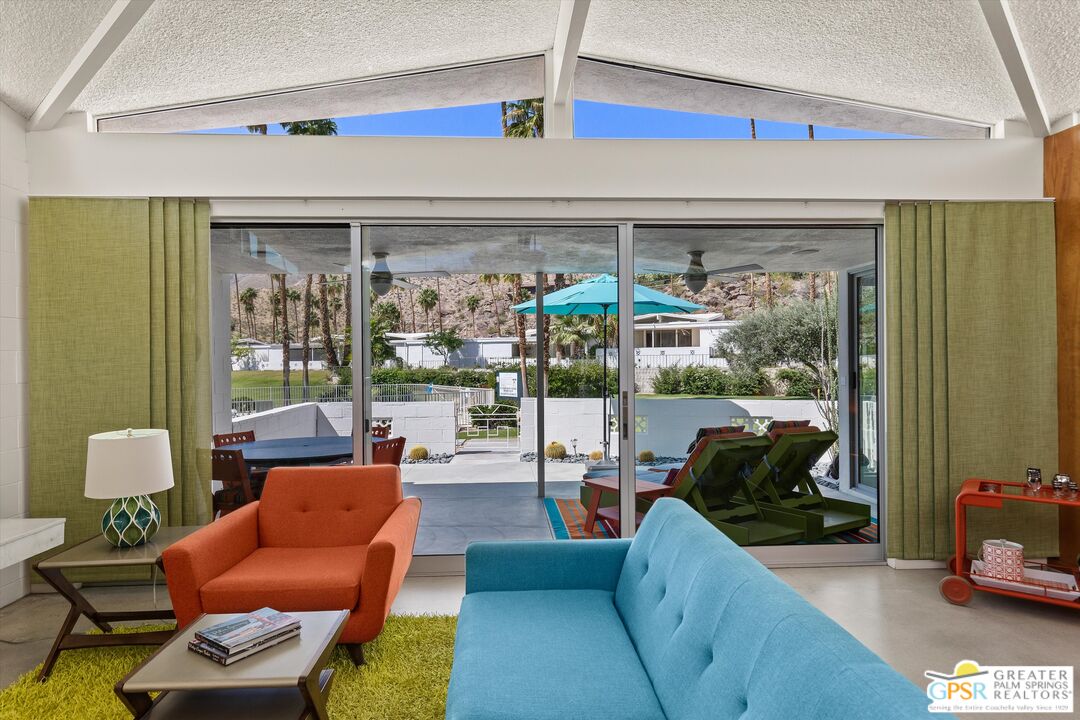 233 Toro Circle Palm Springs, CA 92264 - Photo 9 of 39 a living room with furniture and a large window