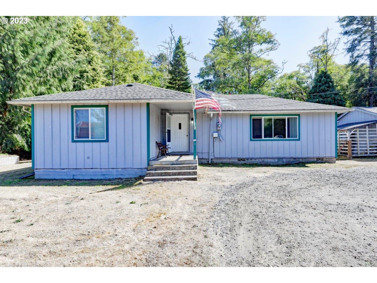 a view of a house with a backyard