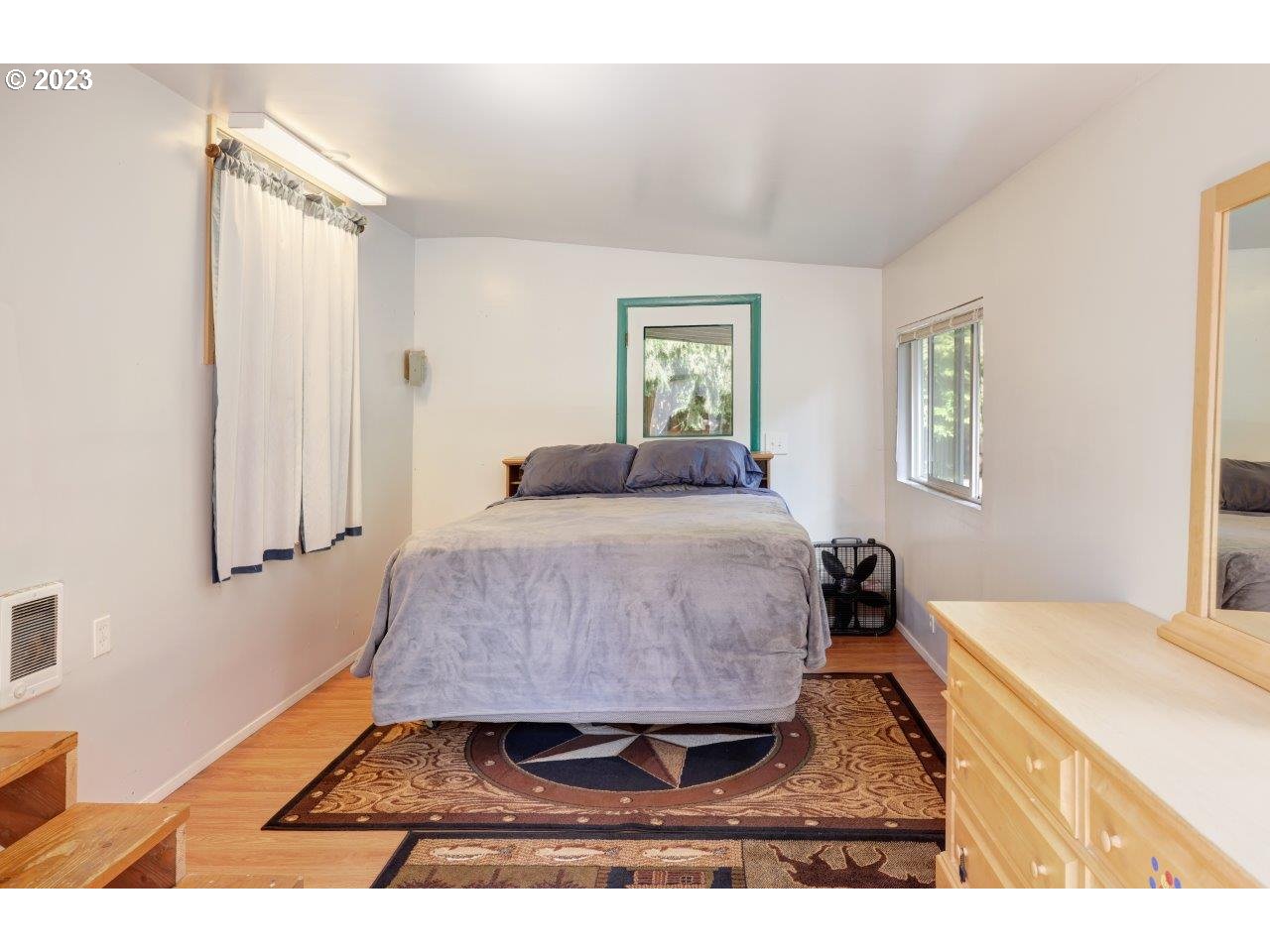 6314 Sandridge Road Long Beach, WA 98631 - Photo 15 of 24 a bedroom with a bed and wooden floor