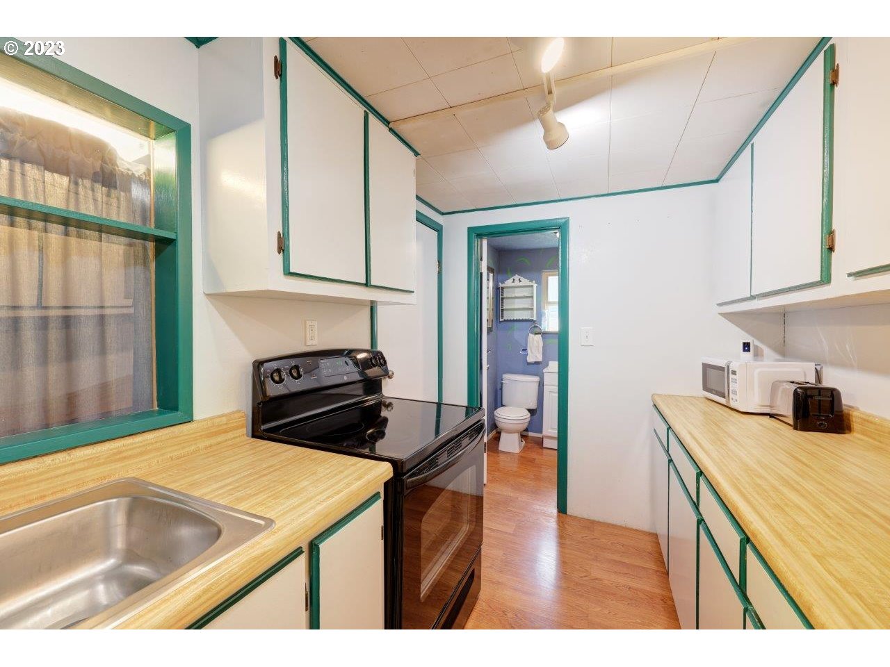 6314 Sandridge Road Long Beach, WA 98631 - Photo 9 of 24 a kitchen that has a sink and a stove