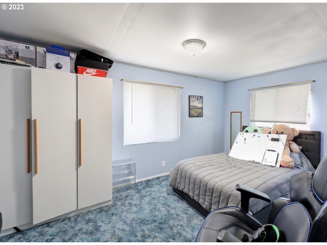 6314 Sandridge Road Long Beach, WA 98631 - Photo 10 of 24 a bedroom with a bed and a refrigerator