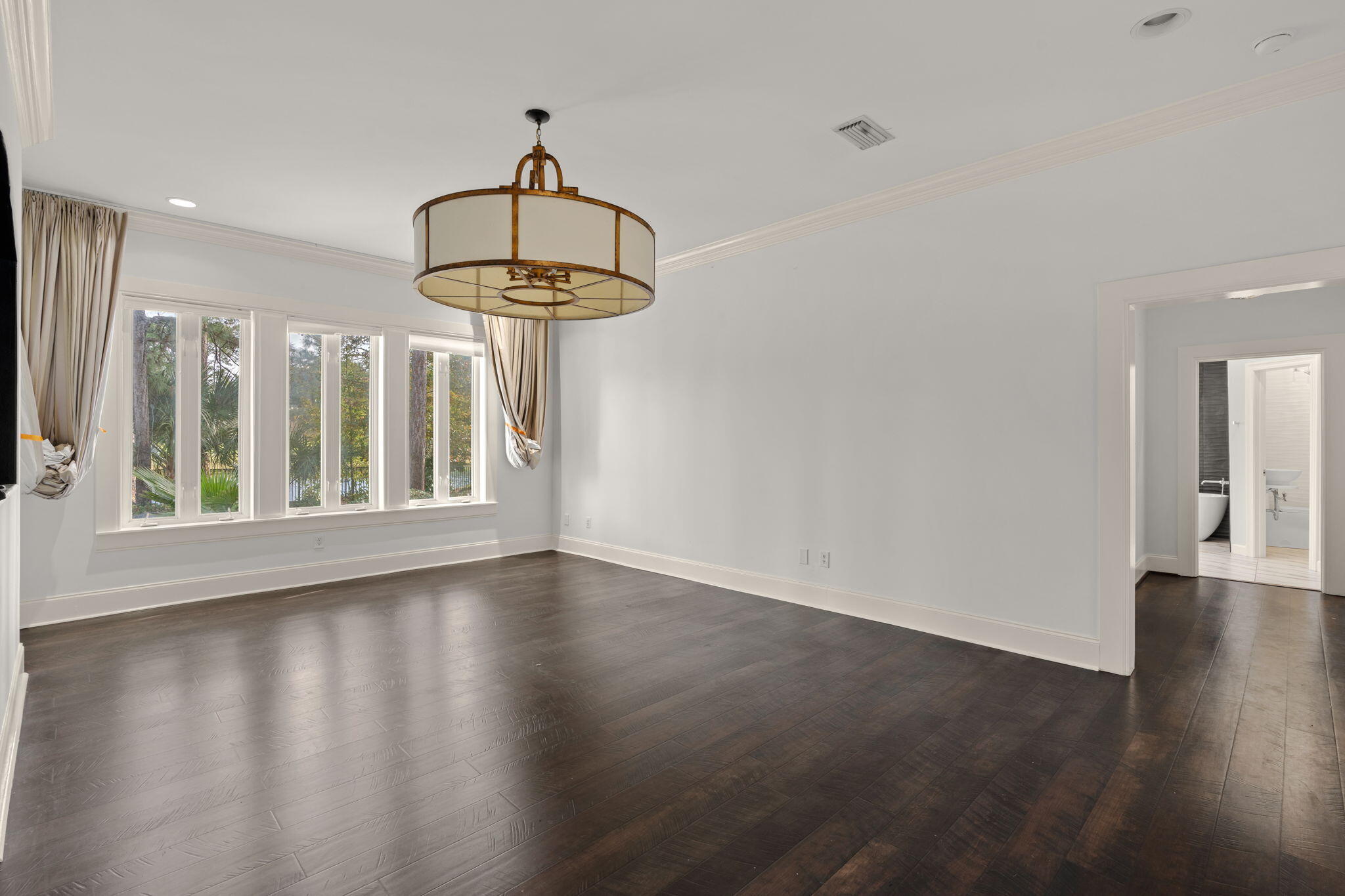 3028 Club Drive Miramar Beach, FL 32550 - Photo 14 of 40 a view of an empty room with wooden floor and a window