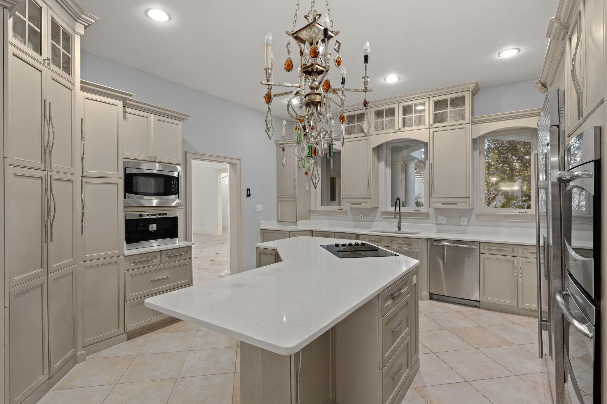 3028 Club Drive Miramar Beach, FL 32550 - Photo 7 of 40 a kitchen that has a lot of cabinets in it and stainless steel appliances