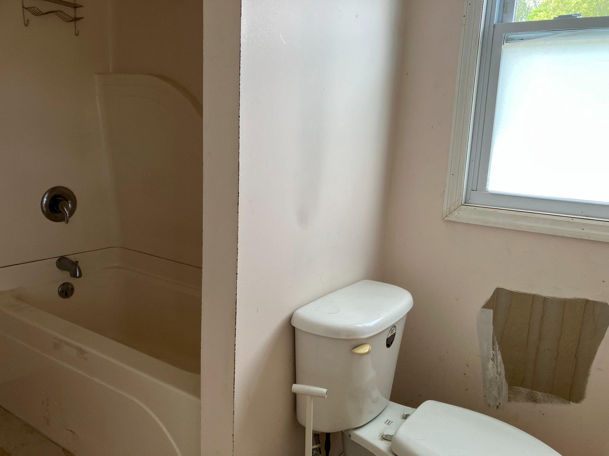 5666 Walnut Street Rock Hall, MD 21661 - Photo 14 of 18 a white toilet sitting next to a bath tub