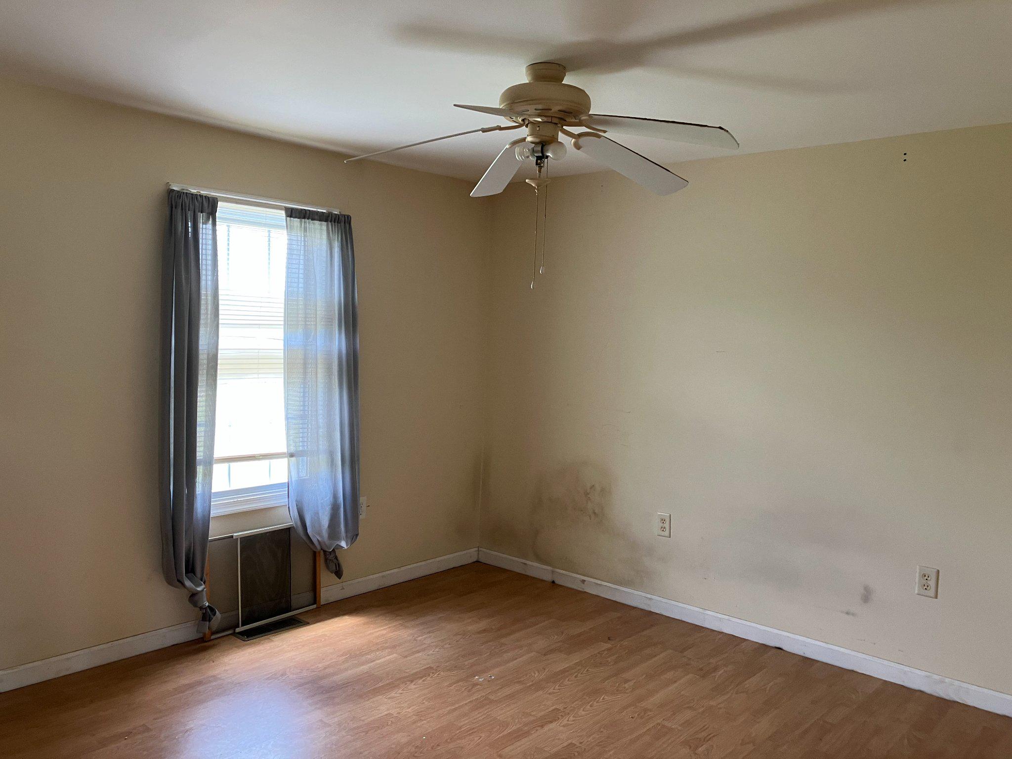 5666 Walnut Street Rock Hall, MD 21661 - Photo 8 of 18 an empty room with a window and a fan