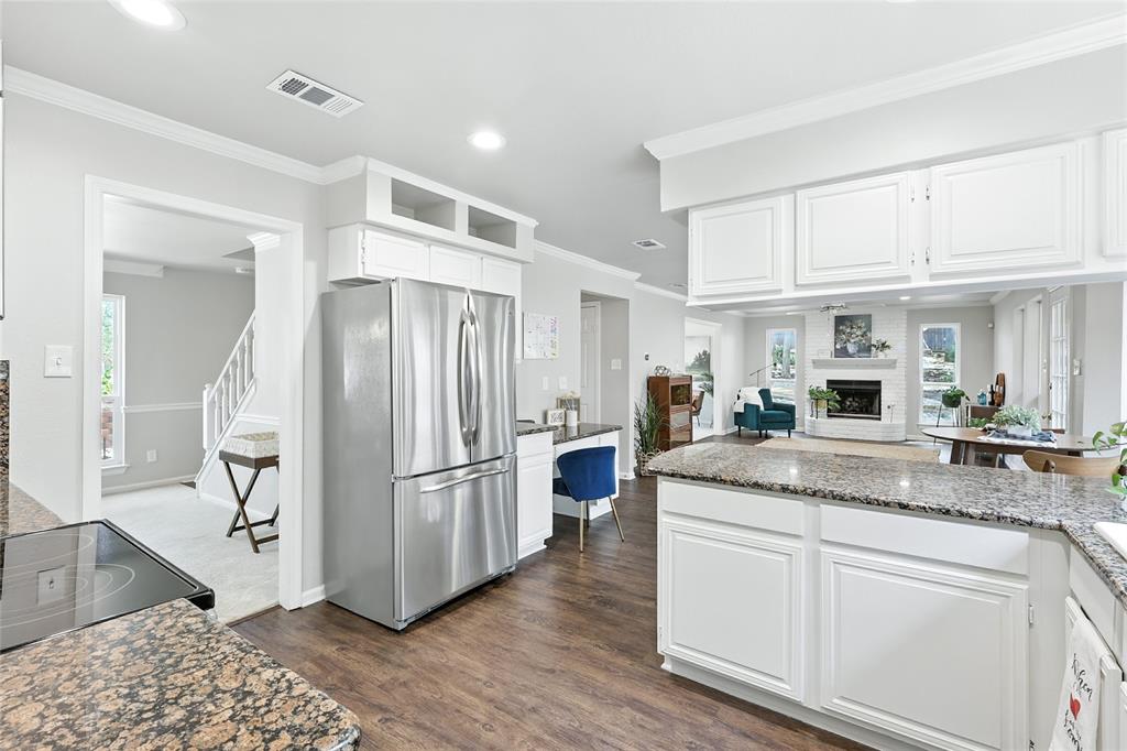 1330 Laredo Court Denton, TX 76205 - Photo 14 of 40 a kitchen with stainless steel appliances granite countertop a refrigerator and a stove top oven
