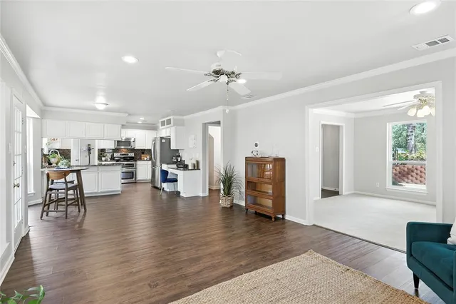 a living room with furniture and kitchen view