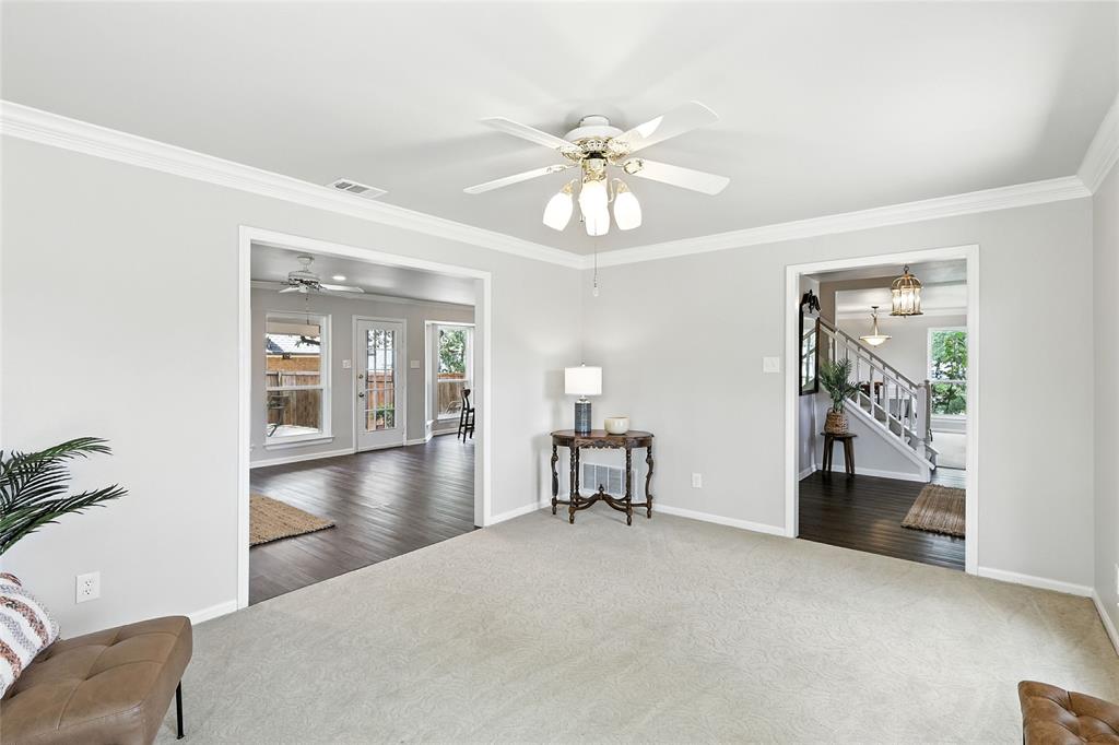 1330 Laredo Court Denton, TX 76205 - Photo 19 of 40 a view of a livingroom with furniture chandelier fan and hallway