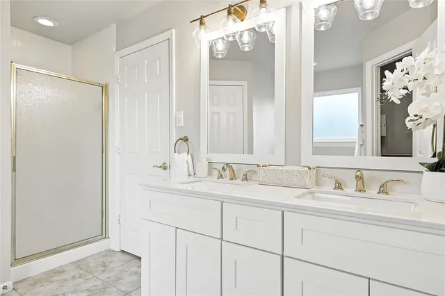 a bathroom with a double vanity sink and mirror