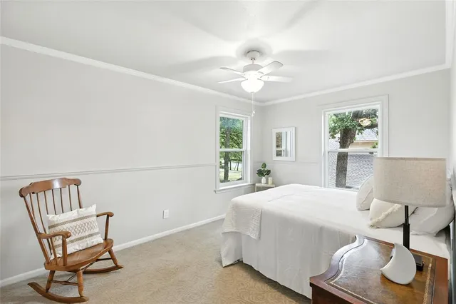 a bedroom with a bed and a chair