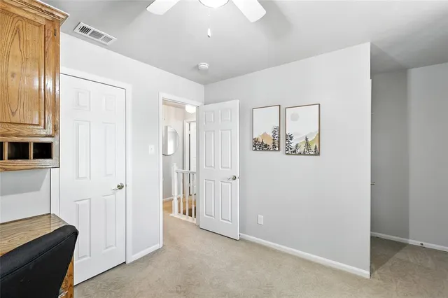 a view of cabinets with stainless steel appliances wooden floor and window