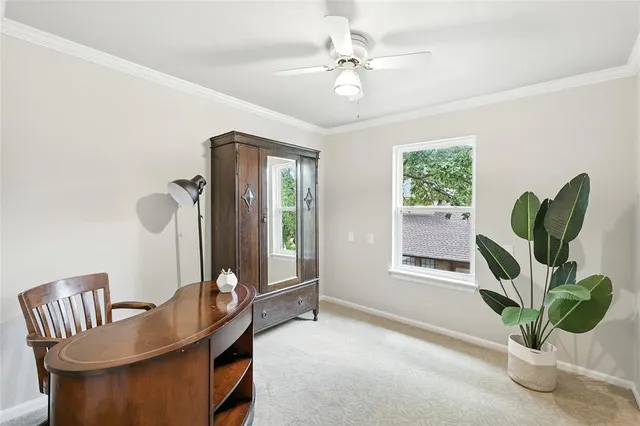 a view of a dining room with furniture and a window