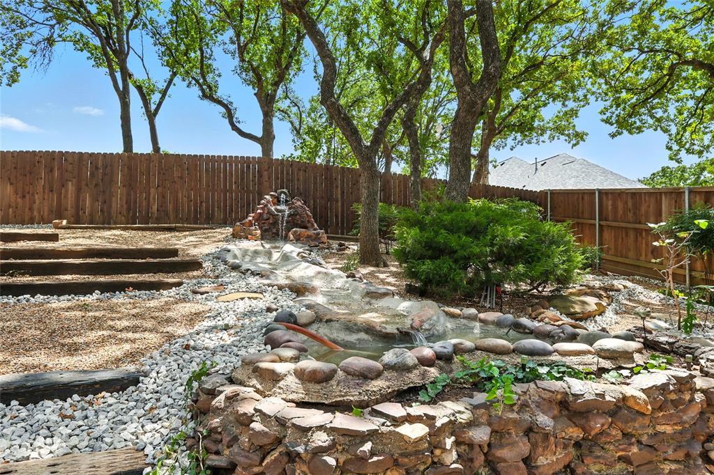 1330 Laredo Court Denton, TX 76205 - Photo 35 of 40 a backyard of a house with lots of green space