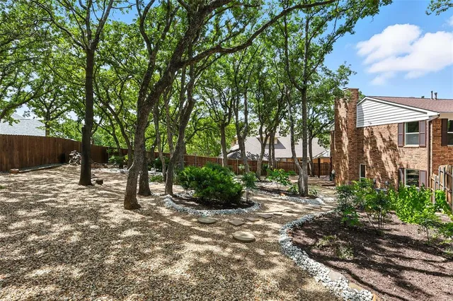 a view of a house with a tree in the background