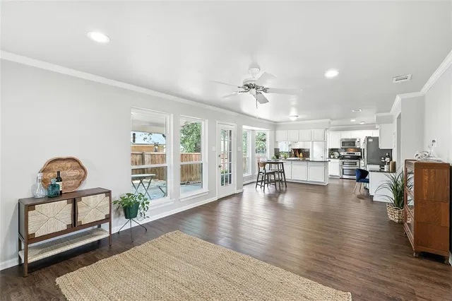 a living room with furniture and kitchen view
