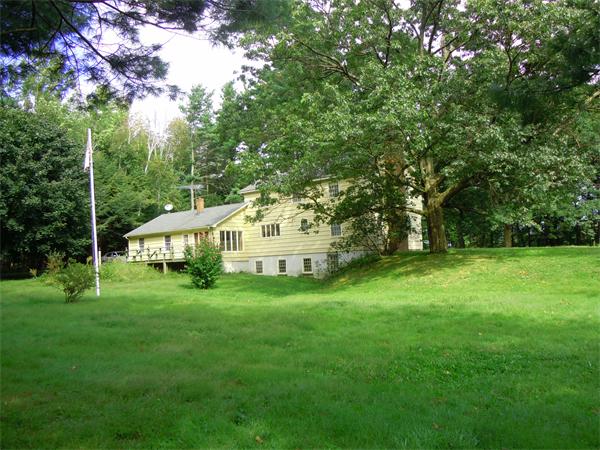 94 Bolton Road Harvard, MA 01451 - Photo 1 of 21 a view of a big house with a big yard and large trees