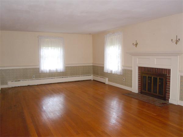 94 Bolton Road Harvard, MA 01451 - Photo 4 of 21 an empty room with wooden floor fireplace and windows