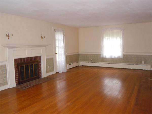 94 Bolton Road Harvard, MA 01451 - Photo 9 of 21 a view of empty room with wooden floor and fireplace