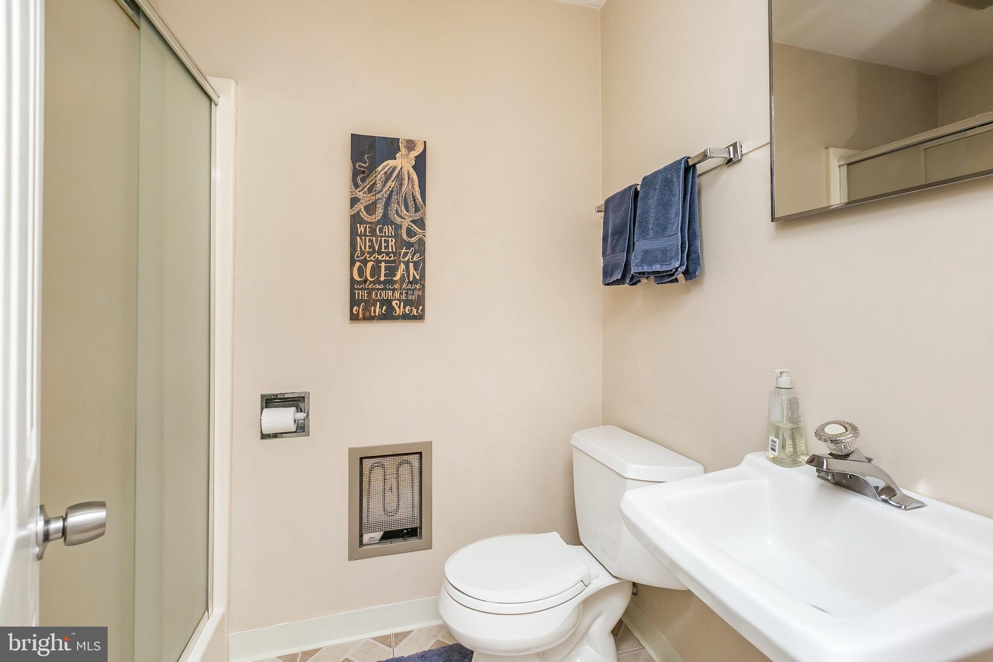 5804 Clearspring Road Baltimore, MD 21212 - Photo 14 of 32 a bathroom with a sink toilet and mirror