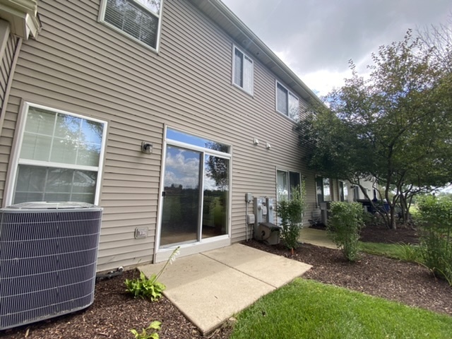 3739 Munson Street Plano, IL 60545 - Photo 20 of 21 a view of a house with a yard and potted plants