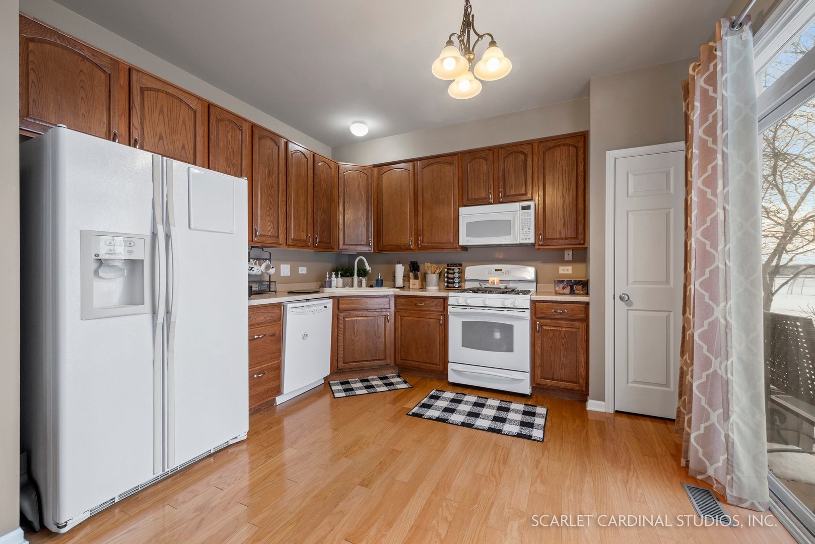 3739 Munson Street Plano, IL 60545 - Photo 8 of 21 a kitchen with a refrigerator a stove top oven a sink and cabinets