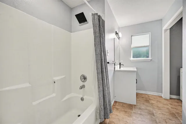 a bathroom with a bathtub and a shower
