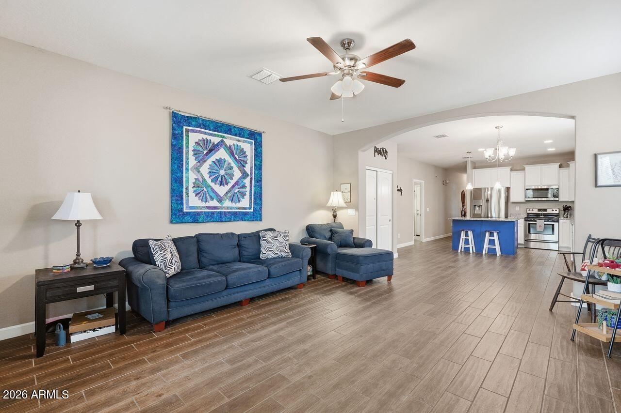 23602 West Ripple Road Buckeye, AZ 85326 - Photo 8 of 38 a living room with furniture and wooden floor