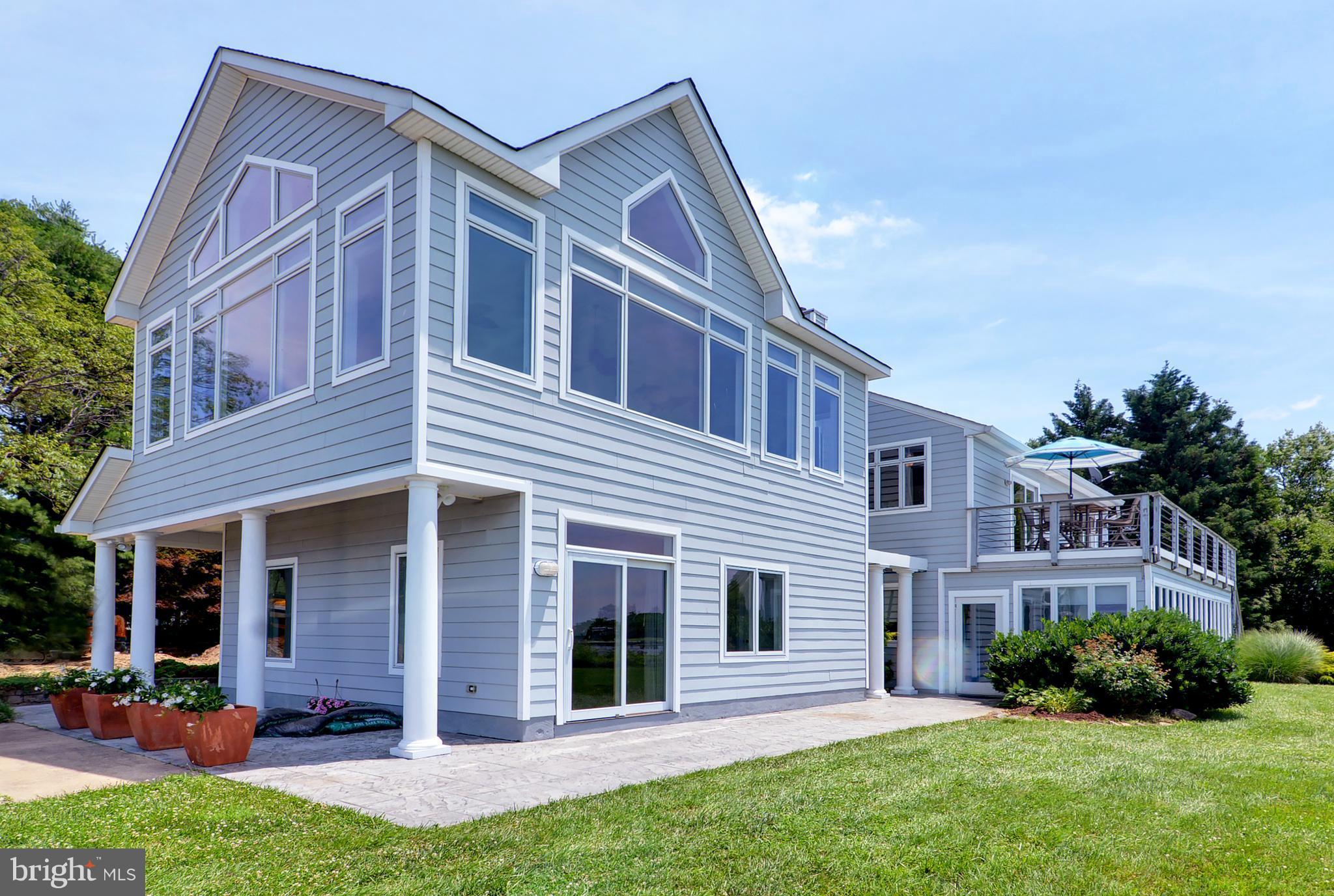 401 Old Point Road Chester, MD 21619 - Photo 2 of 28 a front view of a house with a yard and garage