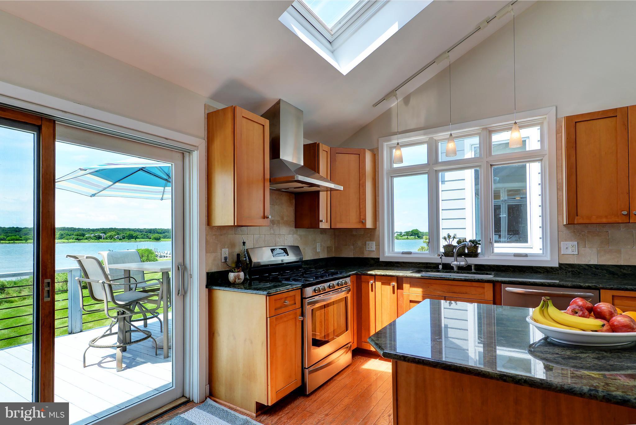 401 Old Point Road Chester, MD 21619 - Photo 14 of 28 a kitchen with stainless steel appliances granite countertop a stove a sink and a microwave