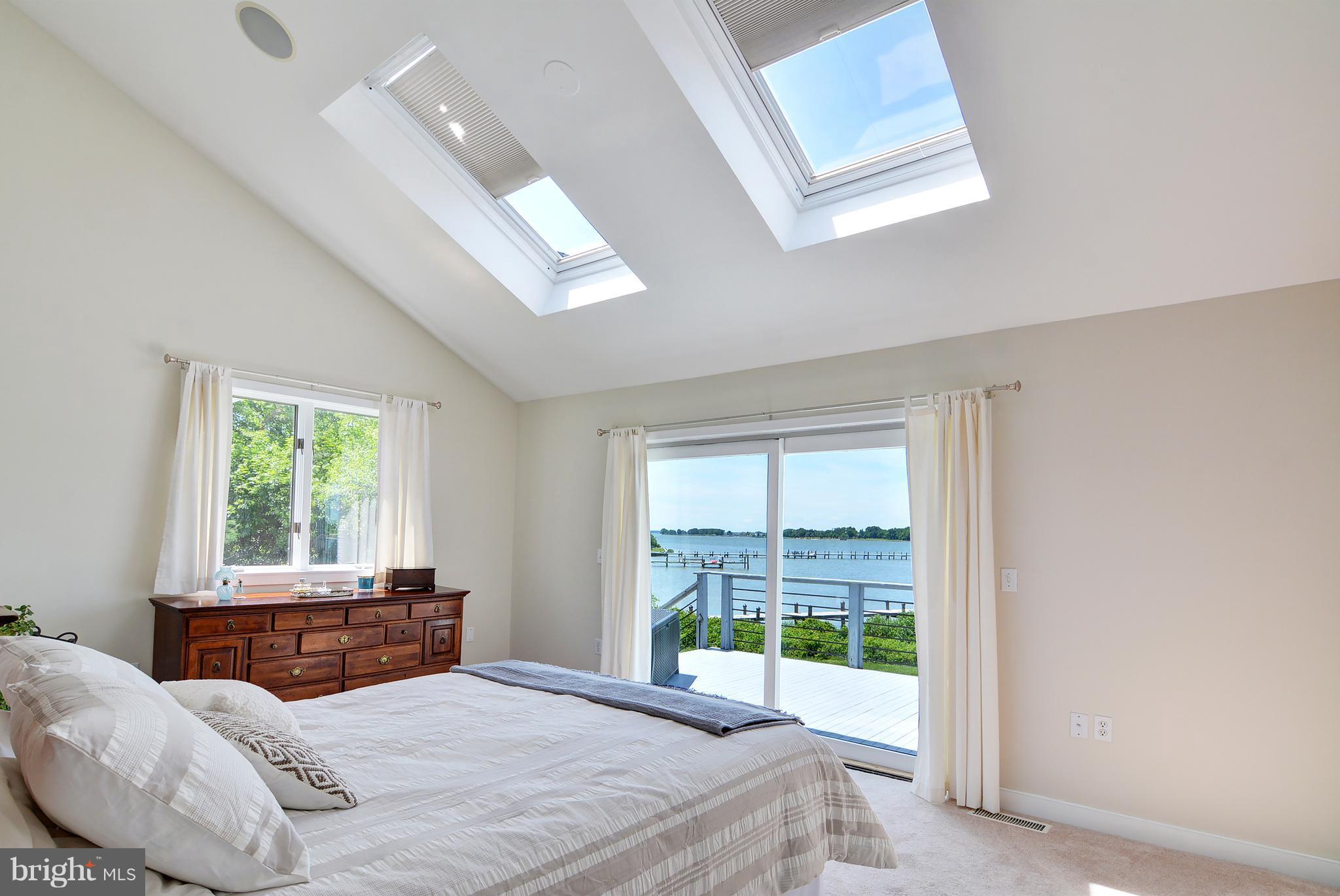 401 Old Point Road Chester, MD 21619 - Photo 15 of 28 a bedroom with a bed and a large window