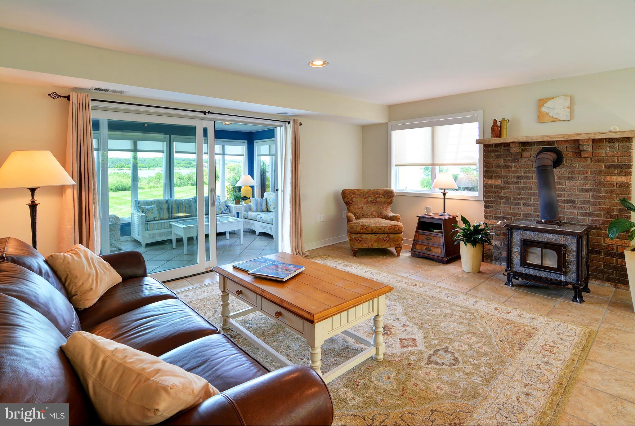 401 Old Point Road Chester, MD 21619 - Photo 23 of 28 a living room with furniture a table and a fireplace