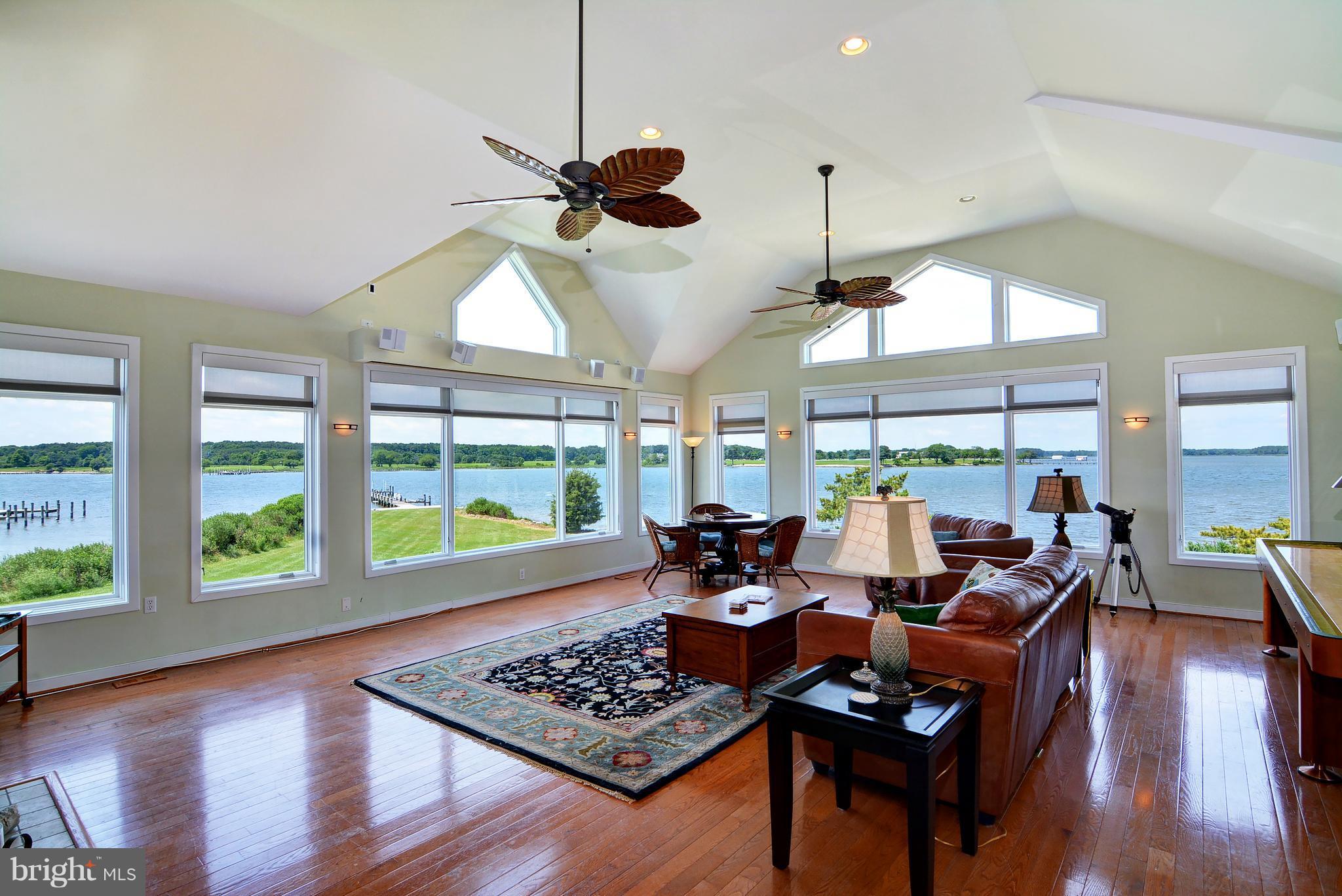 401 Old Point Road Chester, MD 21619 - Photo 9 of 28 a living room with furniture floor to ceiling window and wooden floor