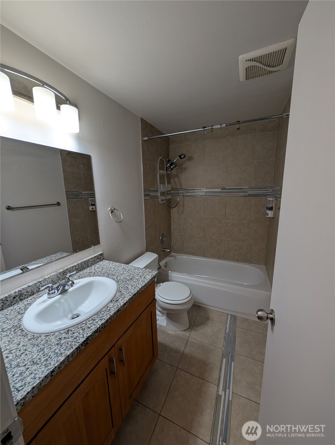 10341 Stone Avenue North Seattle, WA 98133 - Photo 11 of 18 a bathroom with a granite countertop sink toilet and shower