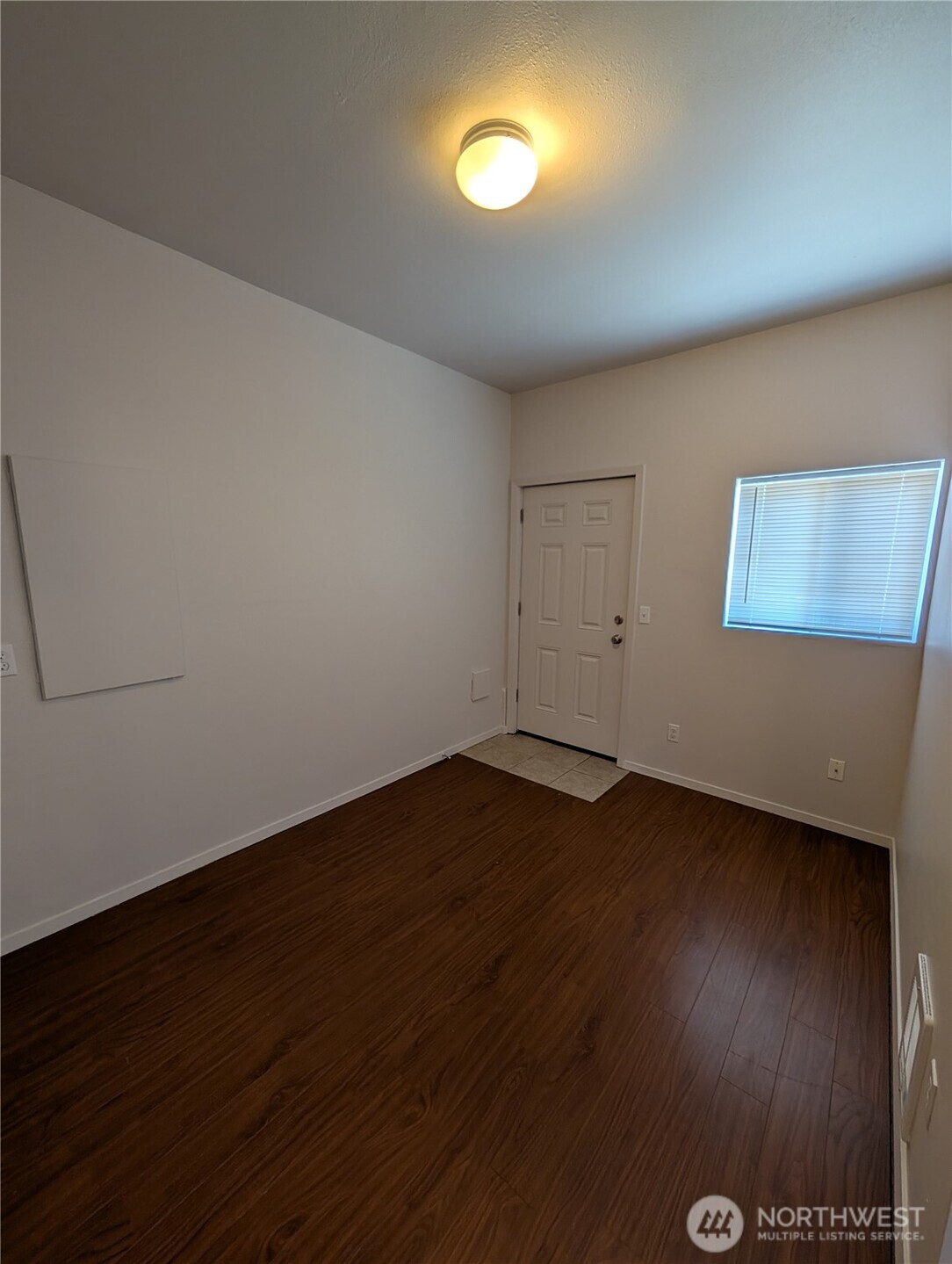 10341 Stone Avenue North Seattle, WA 98133 - Photo 14 of 18 an empty room with wooden floor and windows