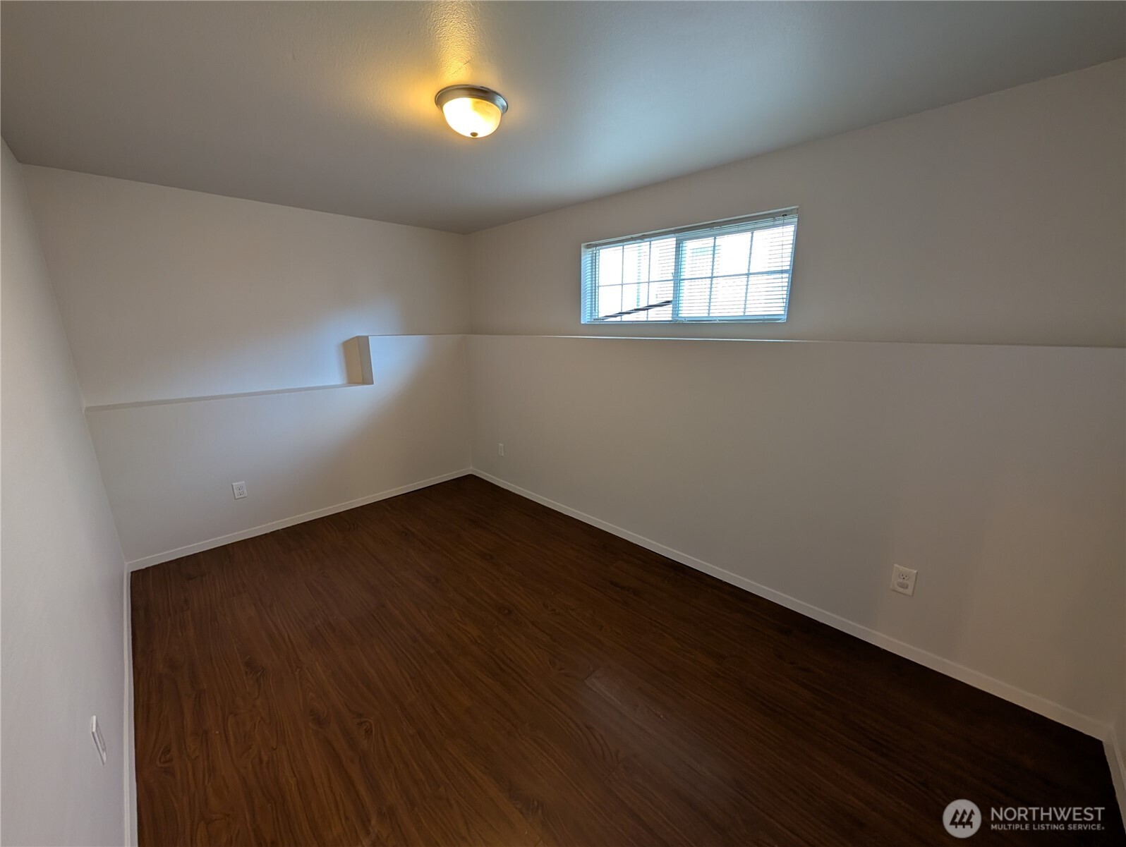 10341 Stone Avenue North Seattle, WA 98133 - Photo 16 of 18 an empty room with wooden floor and windows