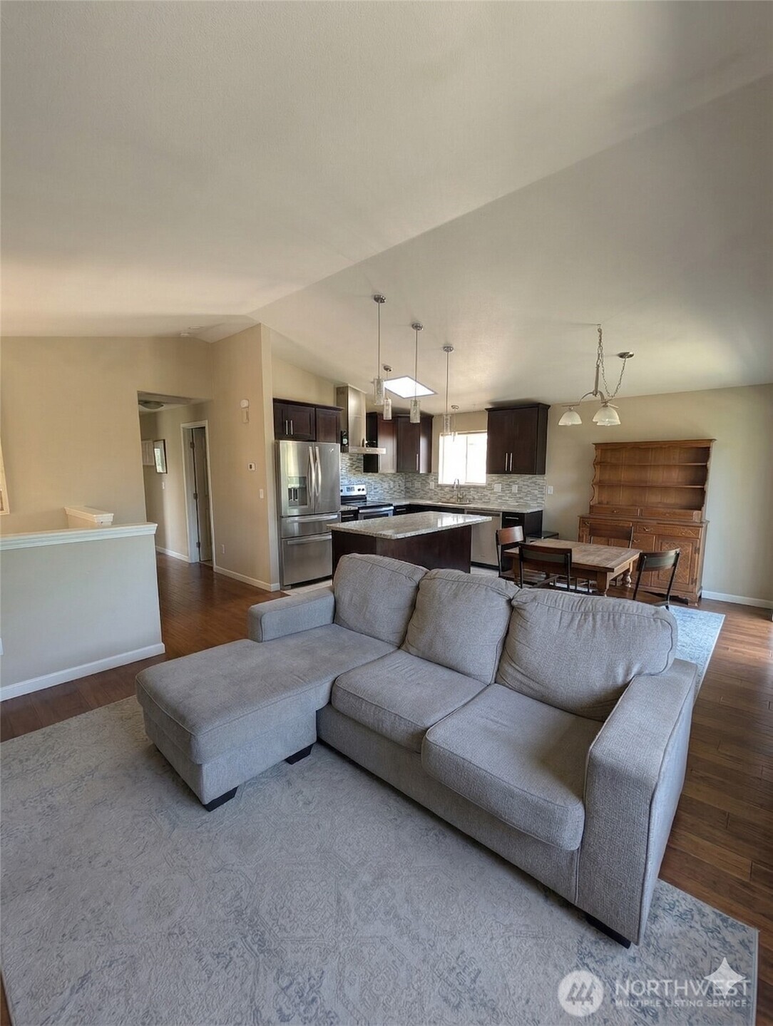 10341 Stone Avenue North Seattle, WA 98133 - Photo 2 of 18 a living room with furniture and kitchen view