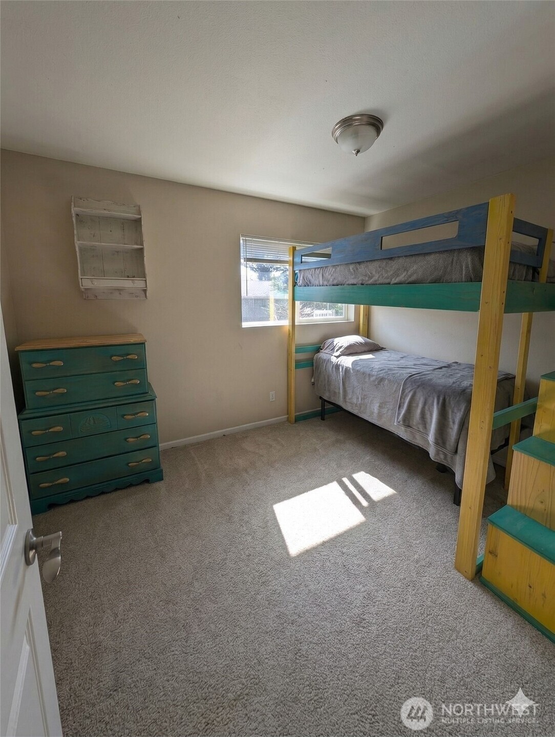 10341 Stone Avenue North Seattle, WA 98133 - Photo 5 of 18 a bed room with a bed and a window