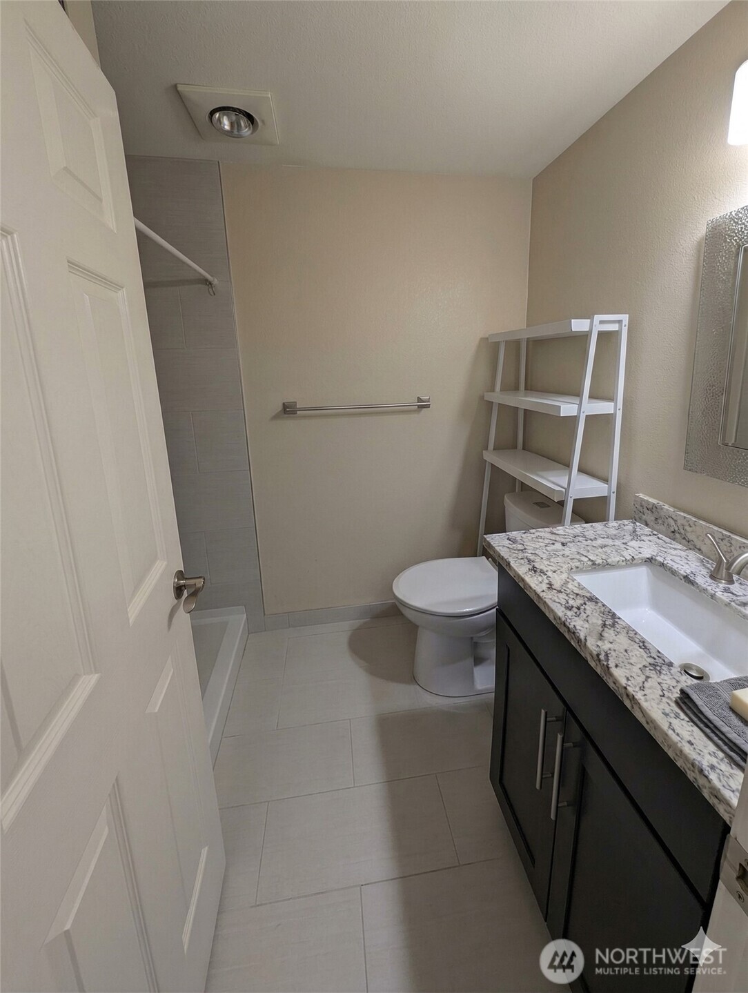 10341 Stone Avenue North Seattle, WA 98133 - Photo 7 of 18 a bathroom with a granite countertop sink toilet and shower