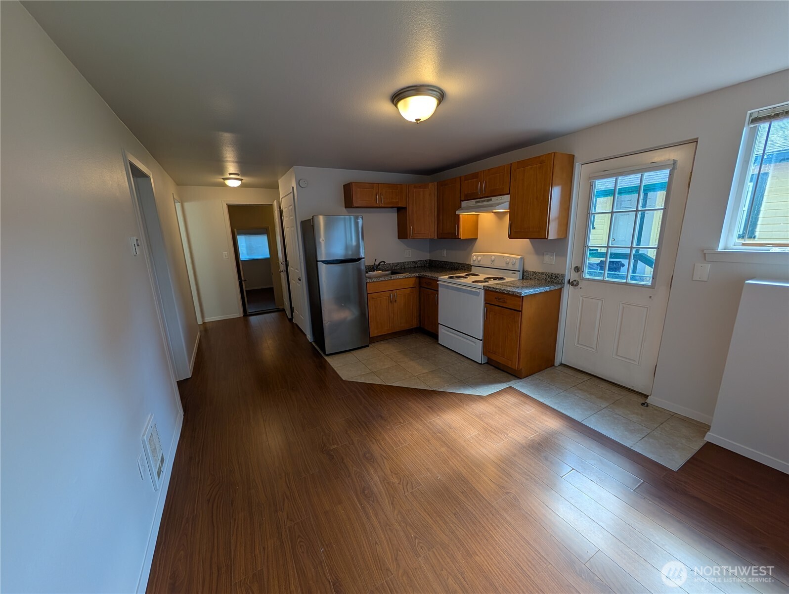 10341 Stone Avenue North Seattle, WA 98133 - Photo 10 of 18 a kitchen with a sink and a stove top oven