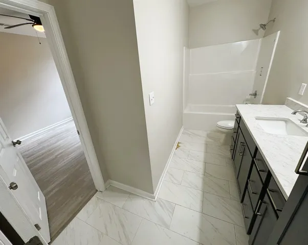 a kitchen with granite countertop a refrigerator and a stove