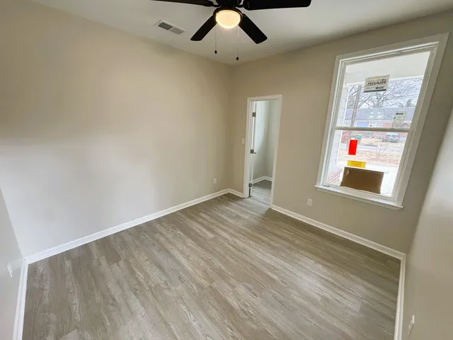 wooden floor in an empty room with a window