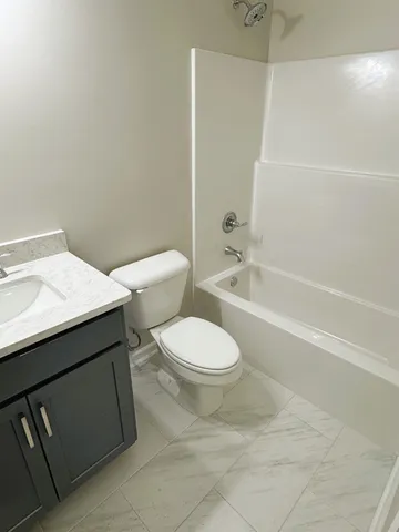 a bathroom with a toilet a sink and bathtub