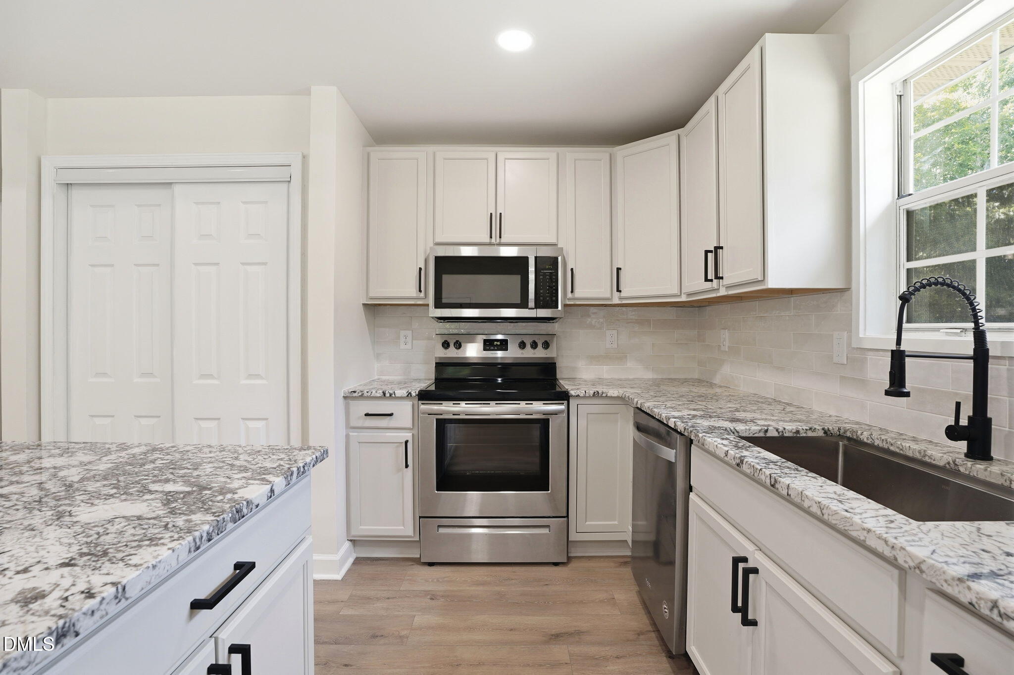 3602 Harrison Road Castalia, NC 27816 - Photo 32 of 48 a kitchen with granite countertop a sink stove and cabinets