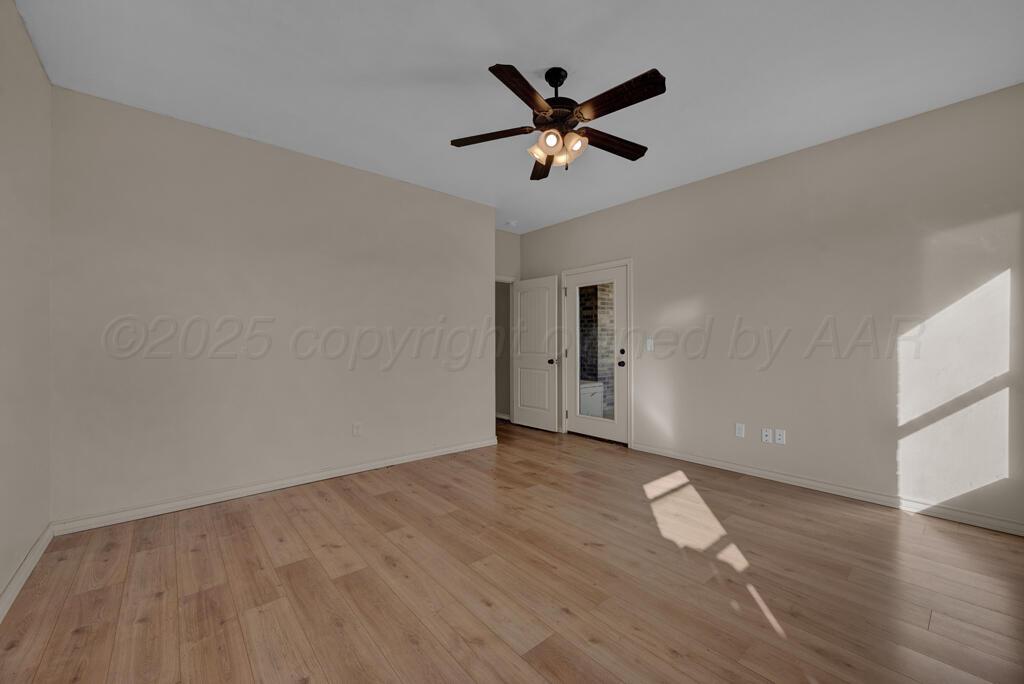 17801 Stone Creek Road Amarillo, TX 79124 - Photo 20 of 31 an empty room with wooden floor and a ceiling fan