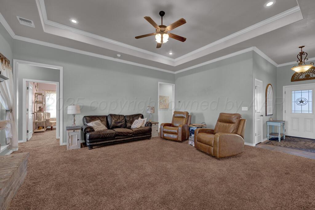 17801 Stone Creek Road Amarillo, TX 79124 - Photo 6 of 31 a living room with furniture and a chandelier
