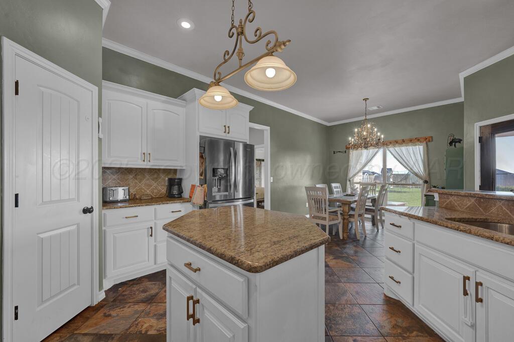 17801 Stone Creek Road Amarillo, TX 79124 - Photo 8 of 31 a kitchen with a table chairs and microwave