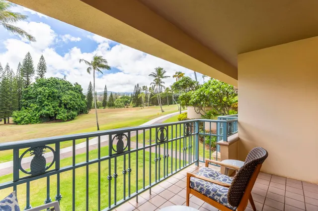 a view of a chair and tables in the balcony