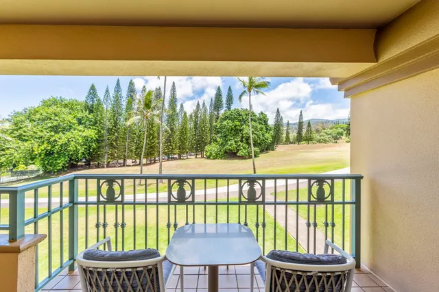 a view of a balcony with chair and wooden floor