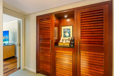 a bedroom with two beds and a large window